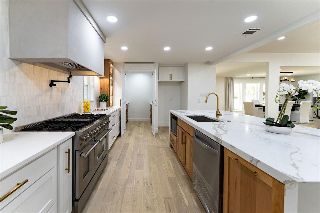 API Kitchen Remodel - Professional range with marble waterfall island