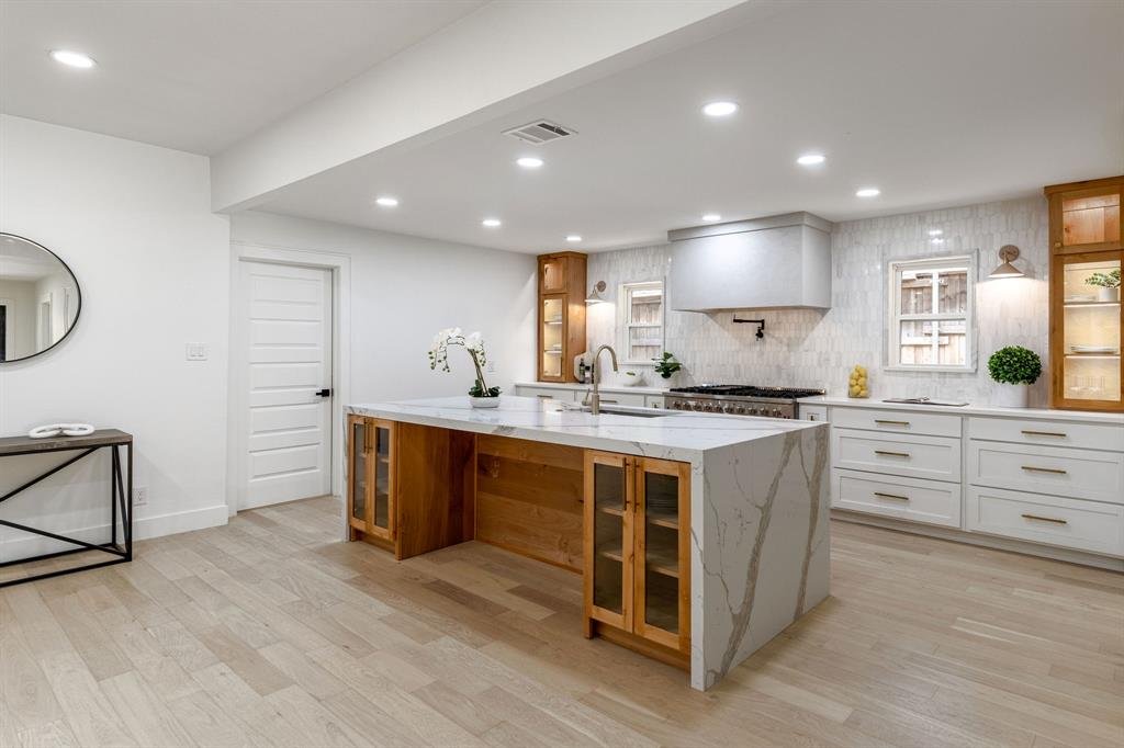 API Kitchen Remodel - Marble island with glass display cabinets